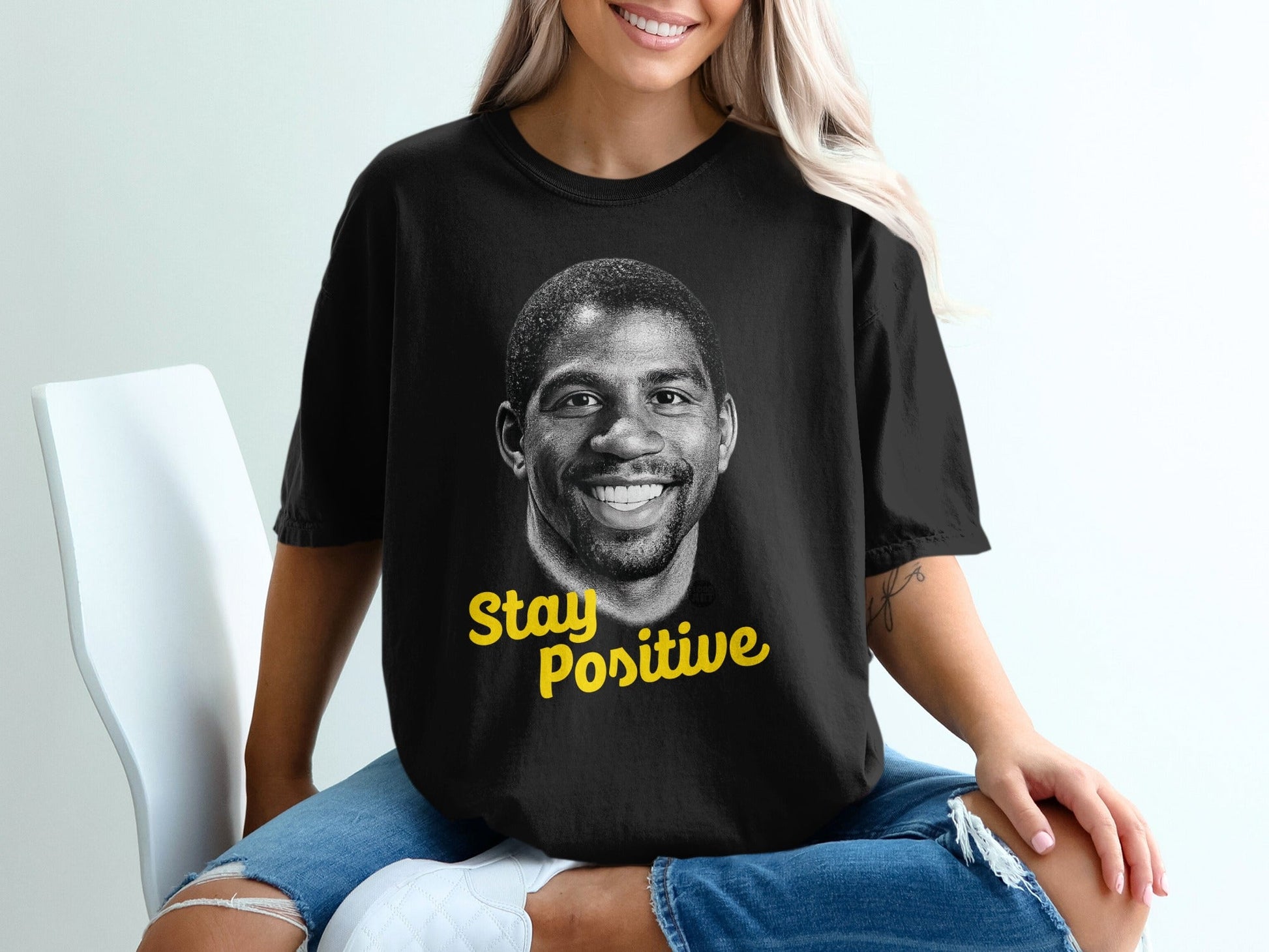 Black t-shirt with Magic Johnson's portrait and "Stay Positive" text.