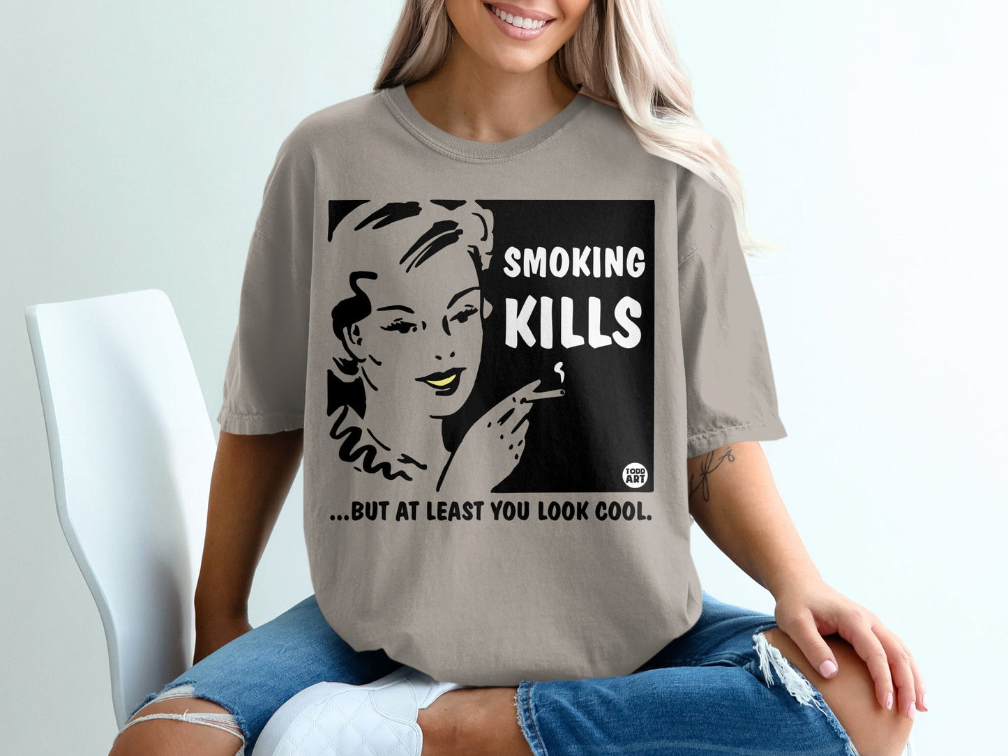 T-shirt graphic with woman smoking, text "SMOKING KILLS... BUT AT LEAST YOU LOOK COOL".