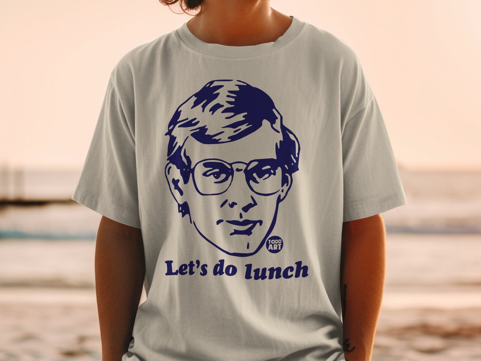 Blue graphic t-shirt with a portrait and "Let's do lunch" text.