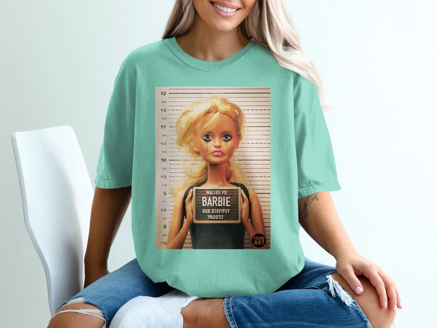T-shirt with a Barbie mugshot design.
