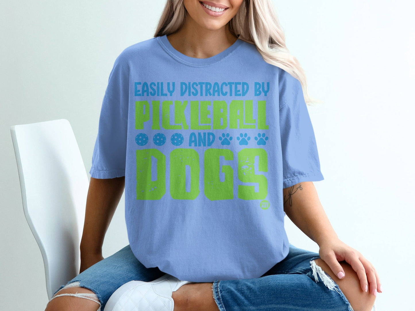 Light blue t-shirt with "Easily Distracted By Pickleball and Dogs" text.
