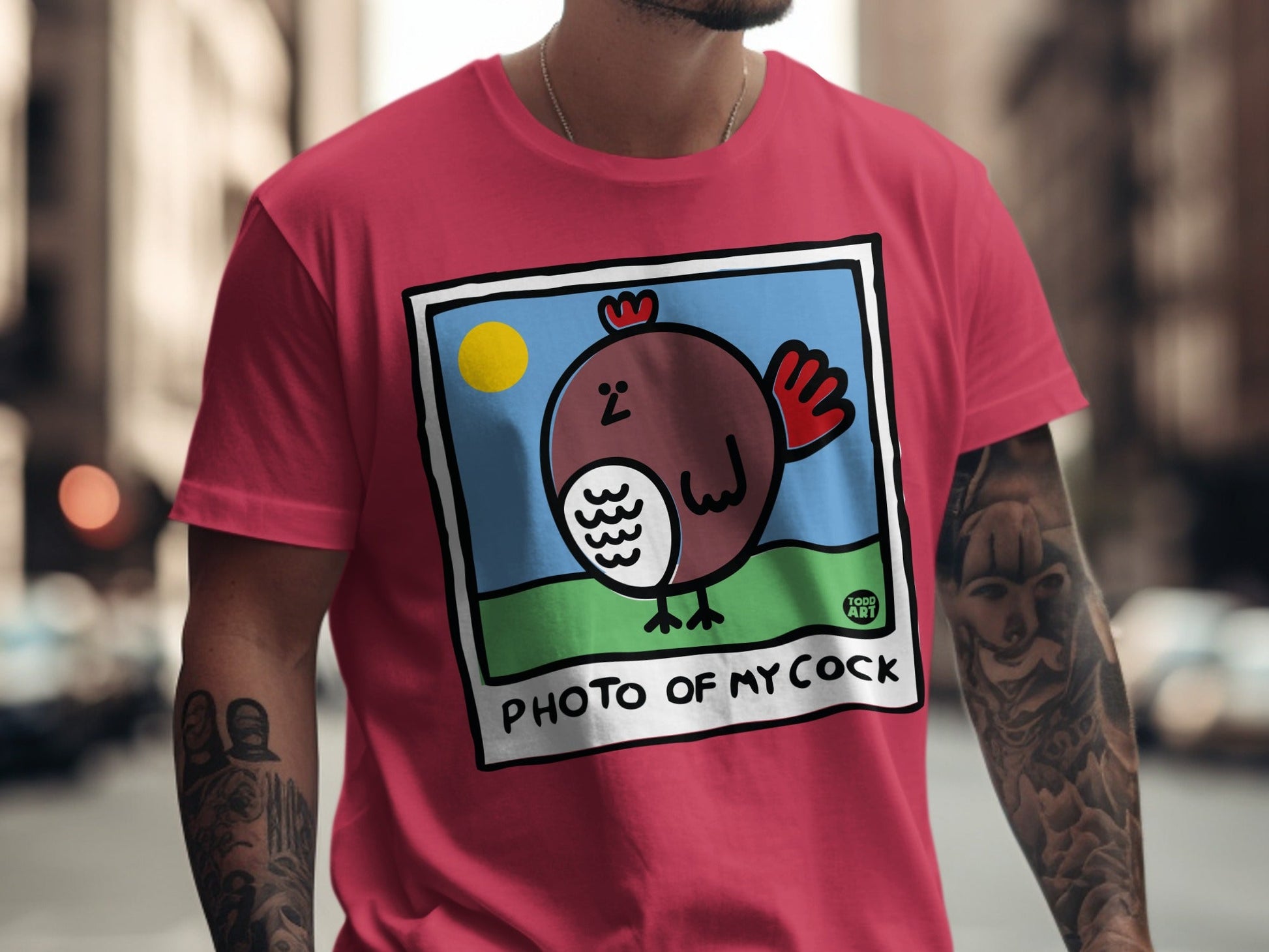 T-shirt with cartoon chicken on a blue sky background, text reads "PHOTO OF MY COCK".