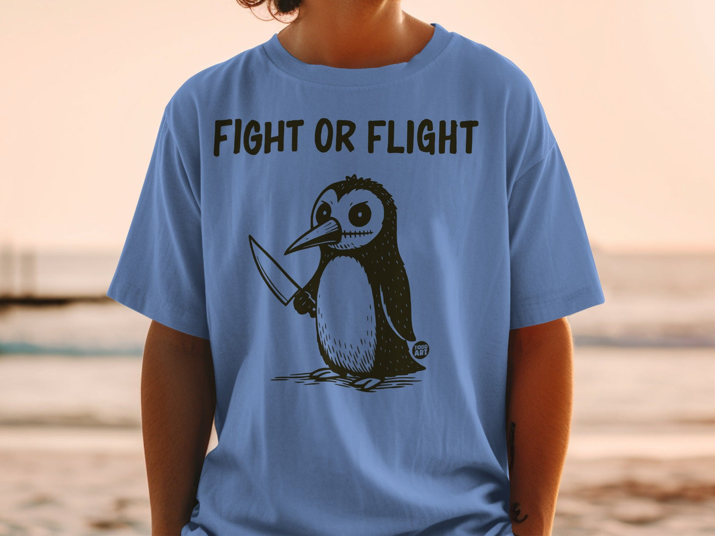 T-shirt with a drawing of a penguin holding a knife and the text "Fight or Flight".