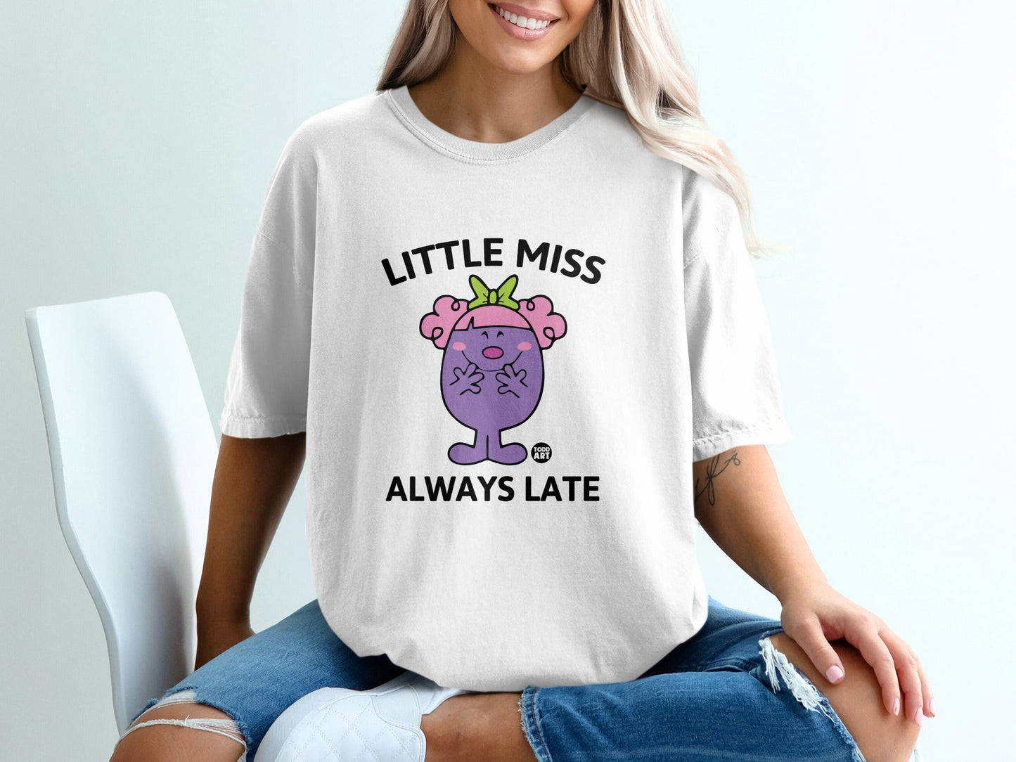 White t-shirt with "Little Miss Always Late" text and cartoon character.