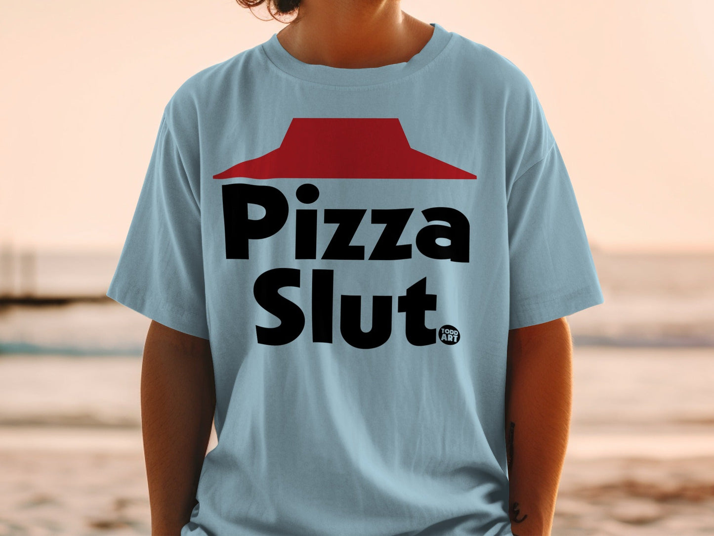 Light blue t-shirt with "Pizza Slut" and "1000 ART" logos.