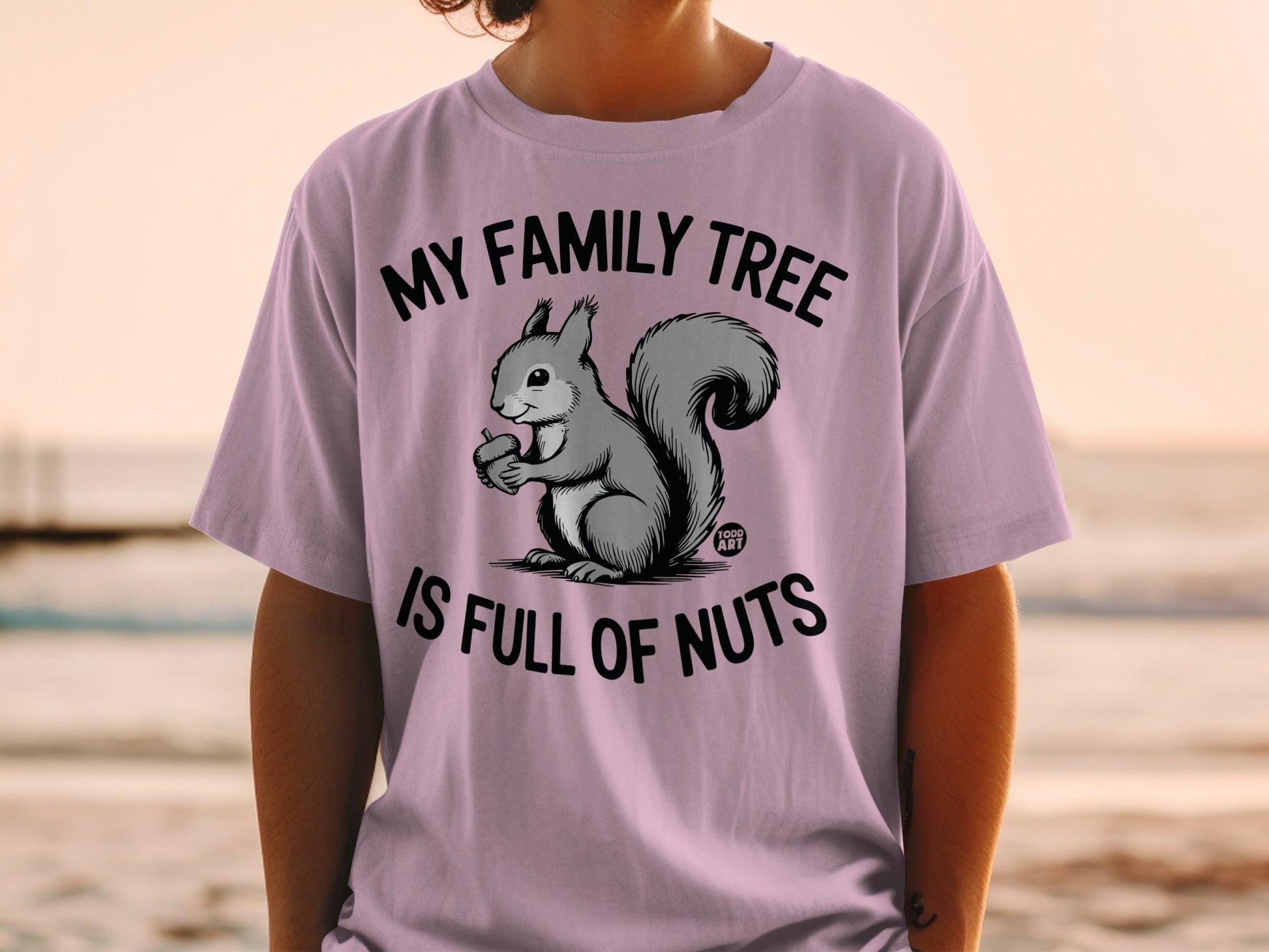 T-shirt with a squirrel holding an acorn and text "My family tree is full of nuts."