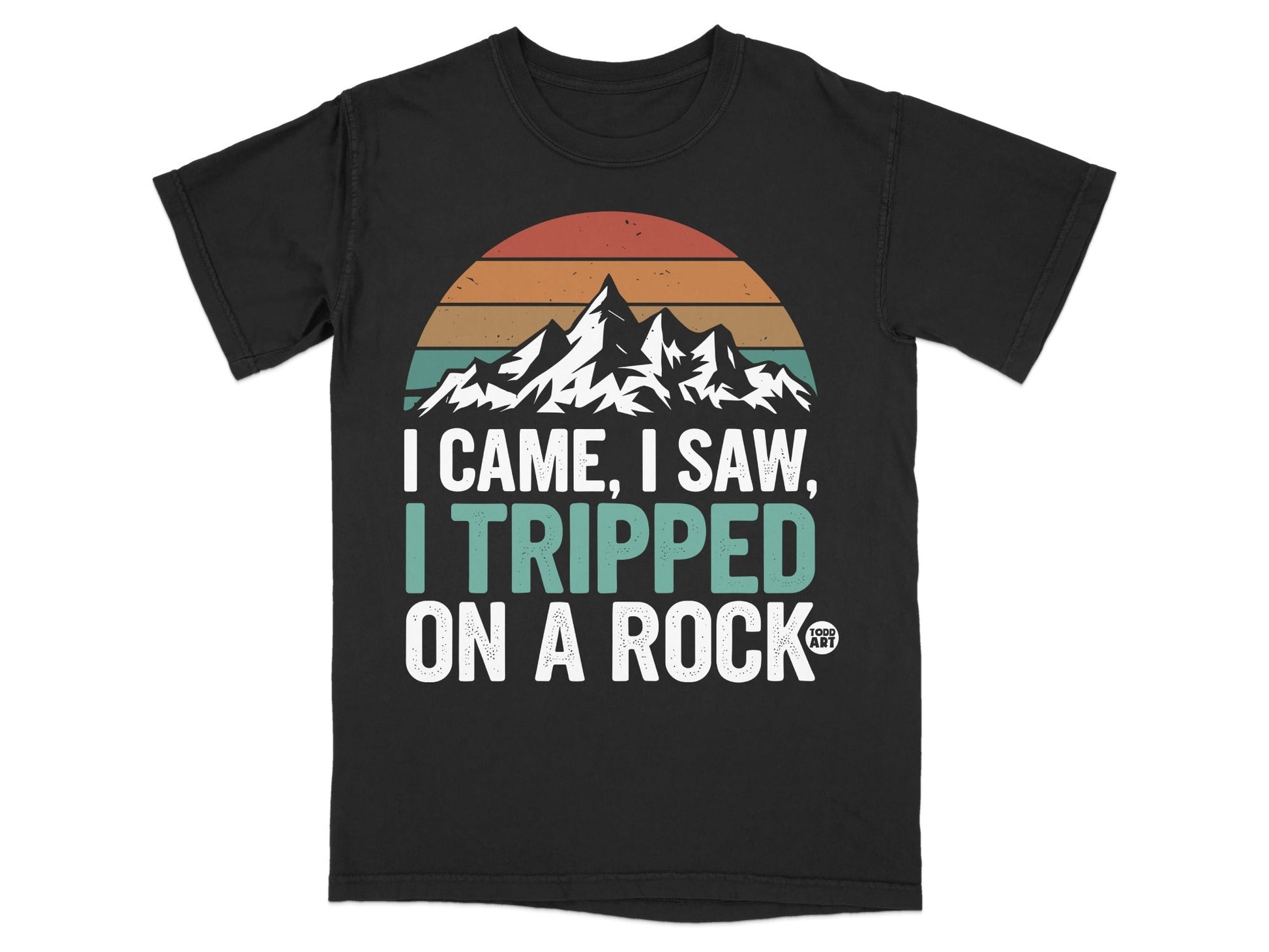 Black t-shirt with "I came, I saw, I tripped on a rock" and mountain sunset graphic.