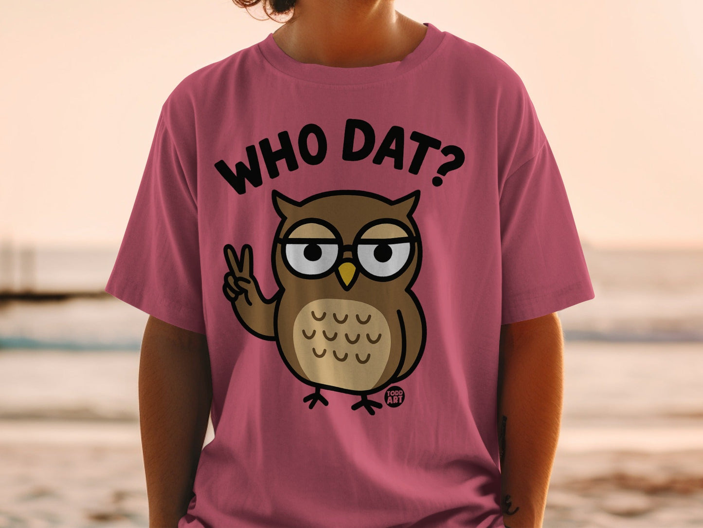 Pink t-shirt with cartoon owl wearing glasses and saying "WHO DAT?".