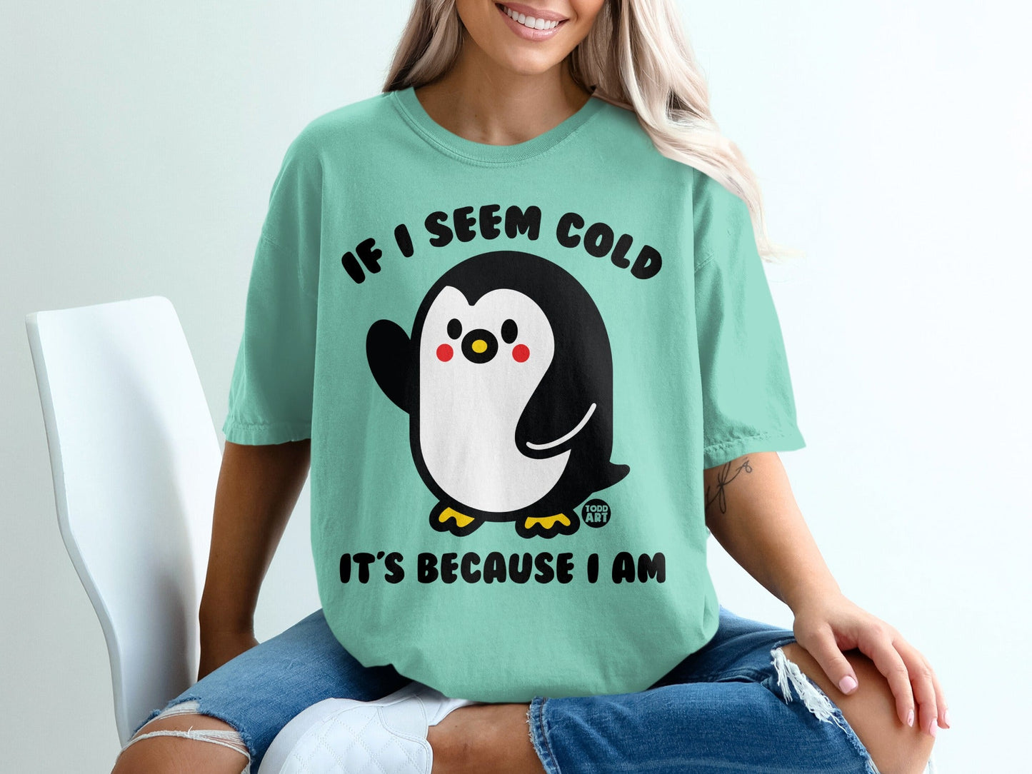 Mint t-shirt with a penguin graphic and text: "If I seem cold, it's because I am."