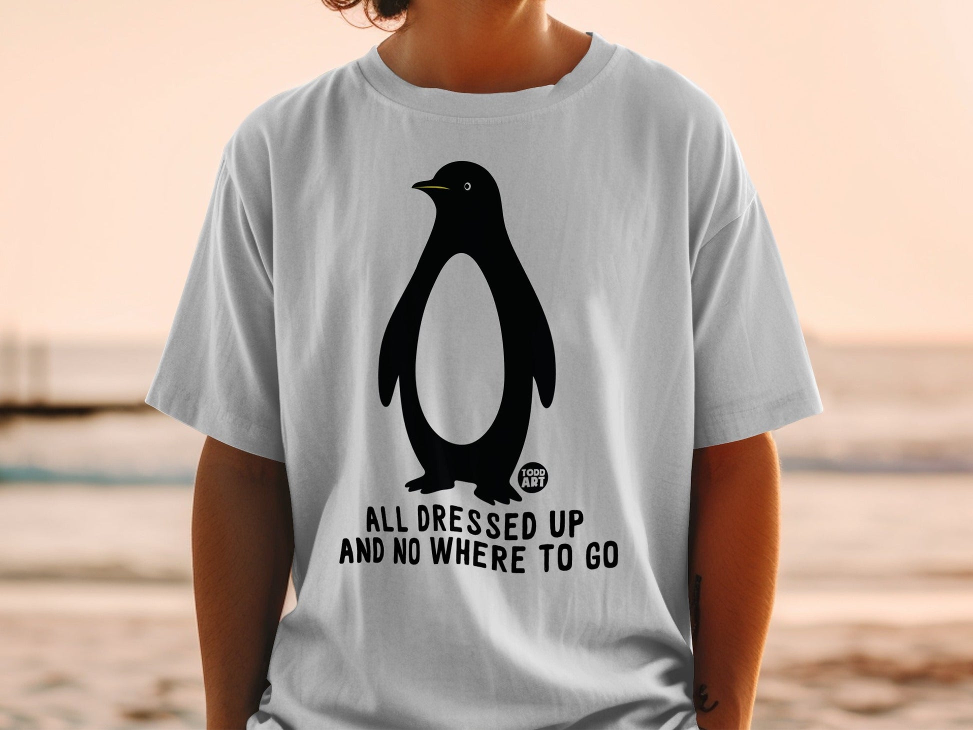 T-shirt with penguin graphic and "ALL DRESSED UP AND NO WHERE TO GO" text.