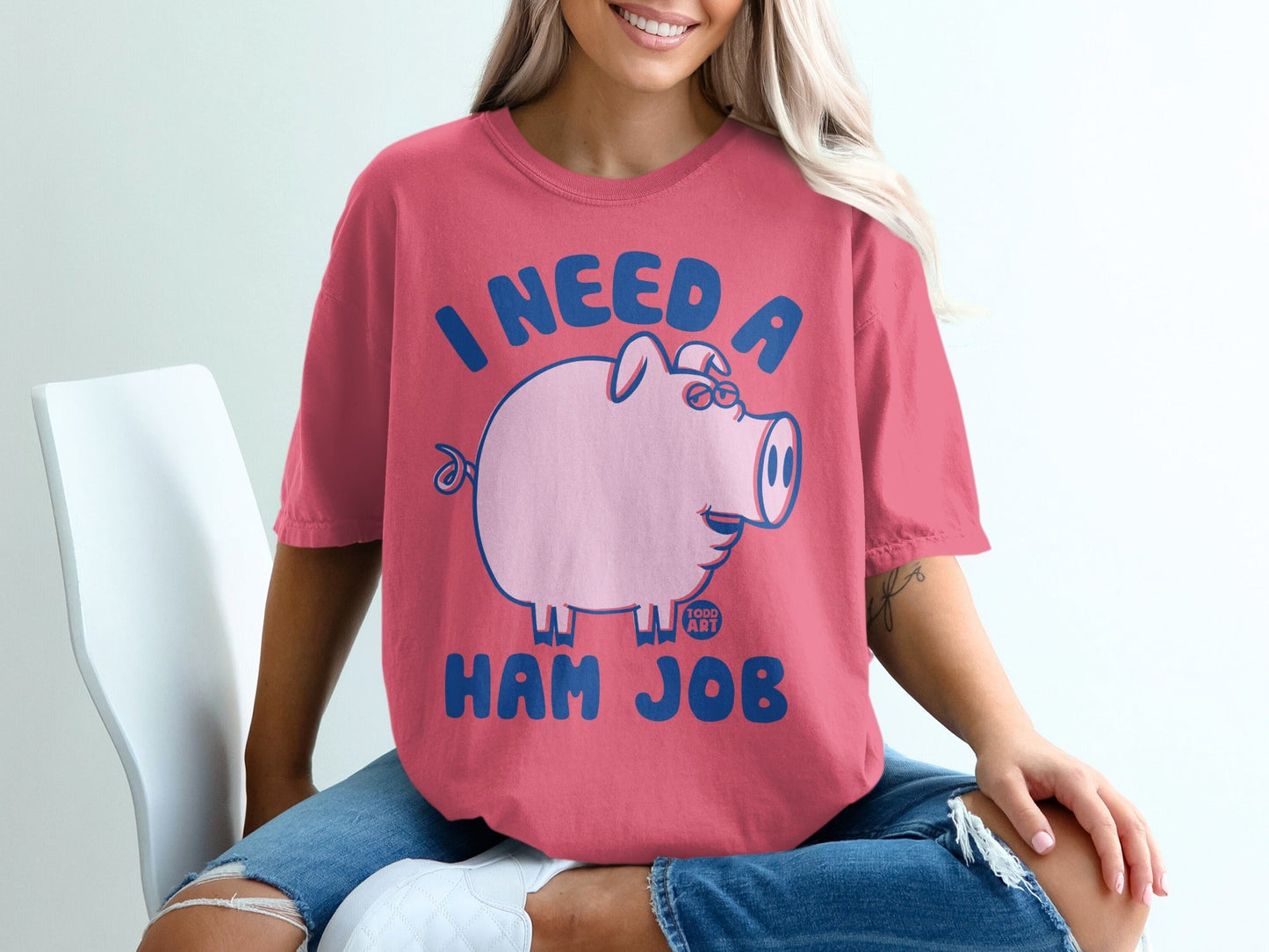 Pink t-shirt with blue text "I NEED A HAM JOB" and a cartoon pig.
