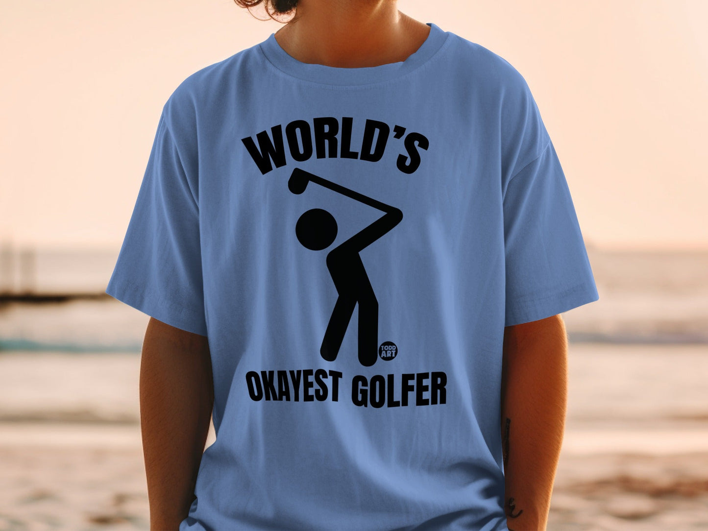 Blue t-shirt with graphic of a golfer and text "WORLD'S OKAYEST GOLFER".