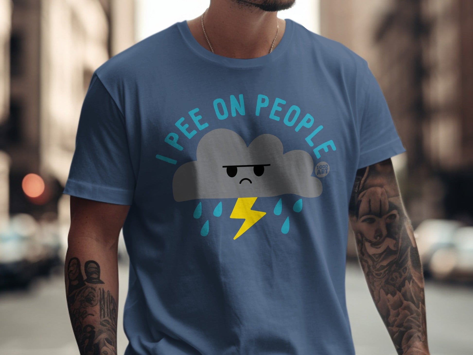 Blue t-shirt with a cartoon cloud, lightning, and rain graphic that says "I pee on people."