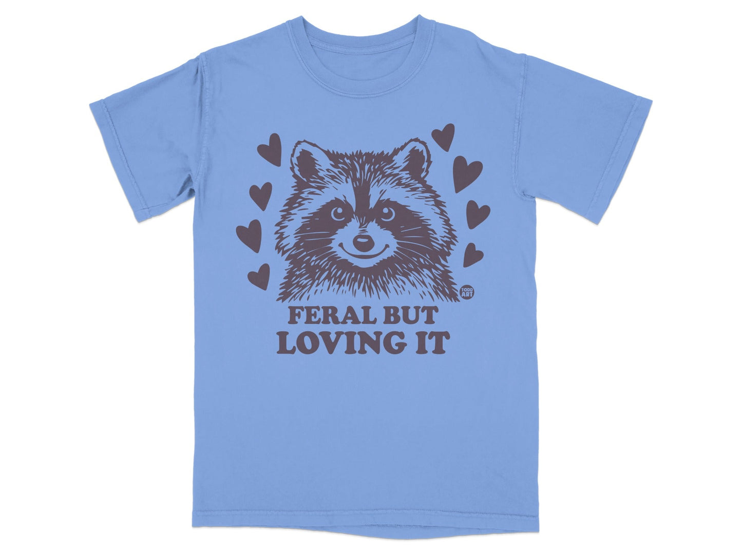 Blue t-shirt with a raccoon graphic and "FERAL BUT LOVING IT" text.