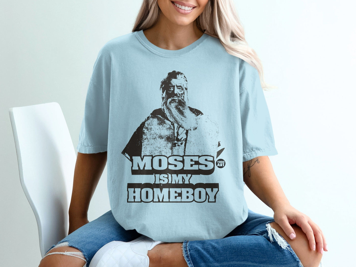 Light blue t-shirt with "MOSES IS MY HOMEBOY" and portrait.