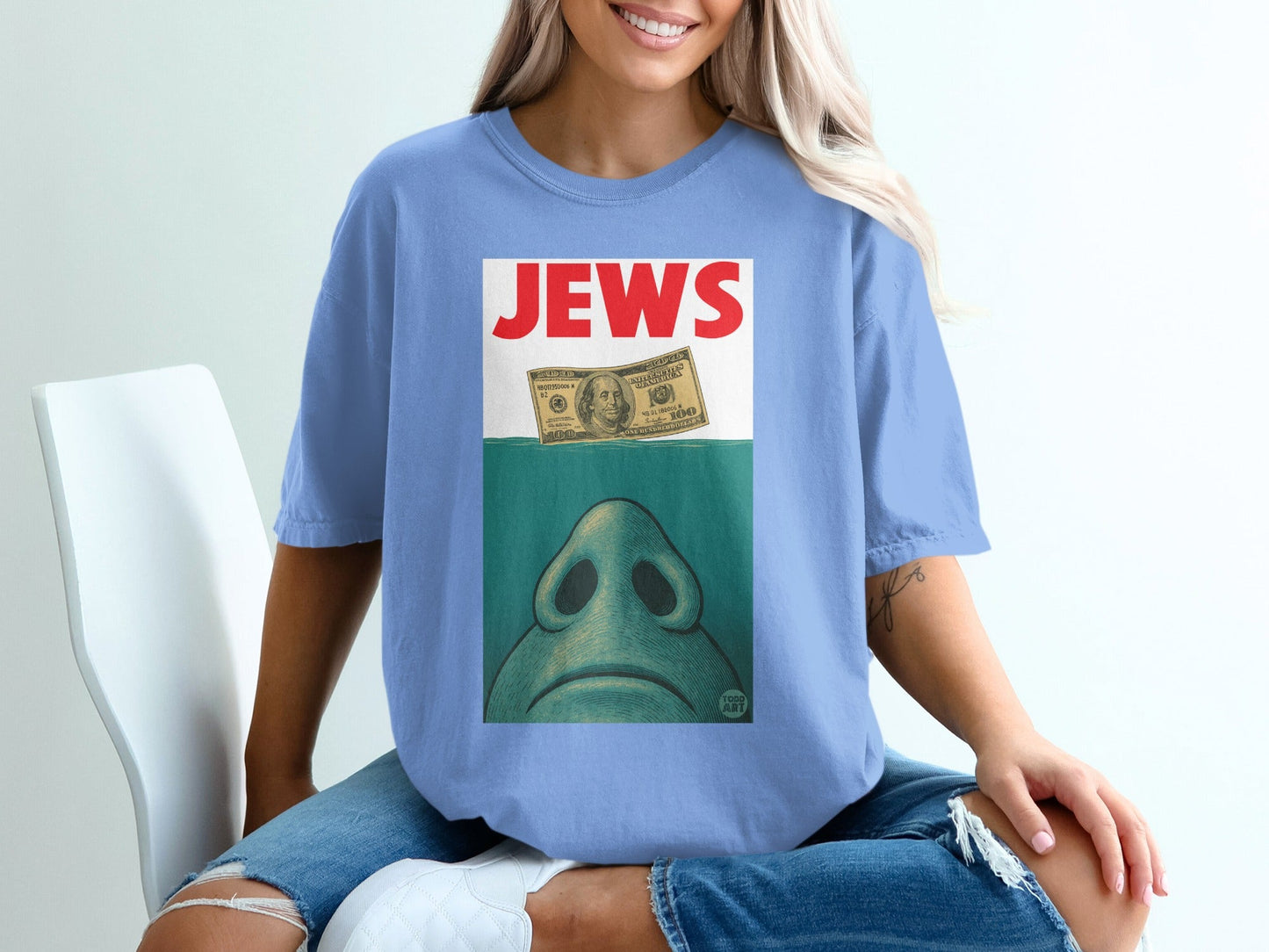 T-shirt with a stylized shark fin, money, and text that reads "JEWS".