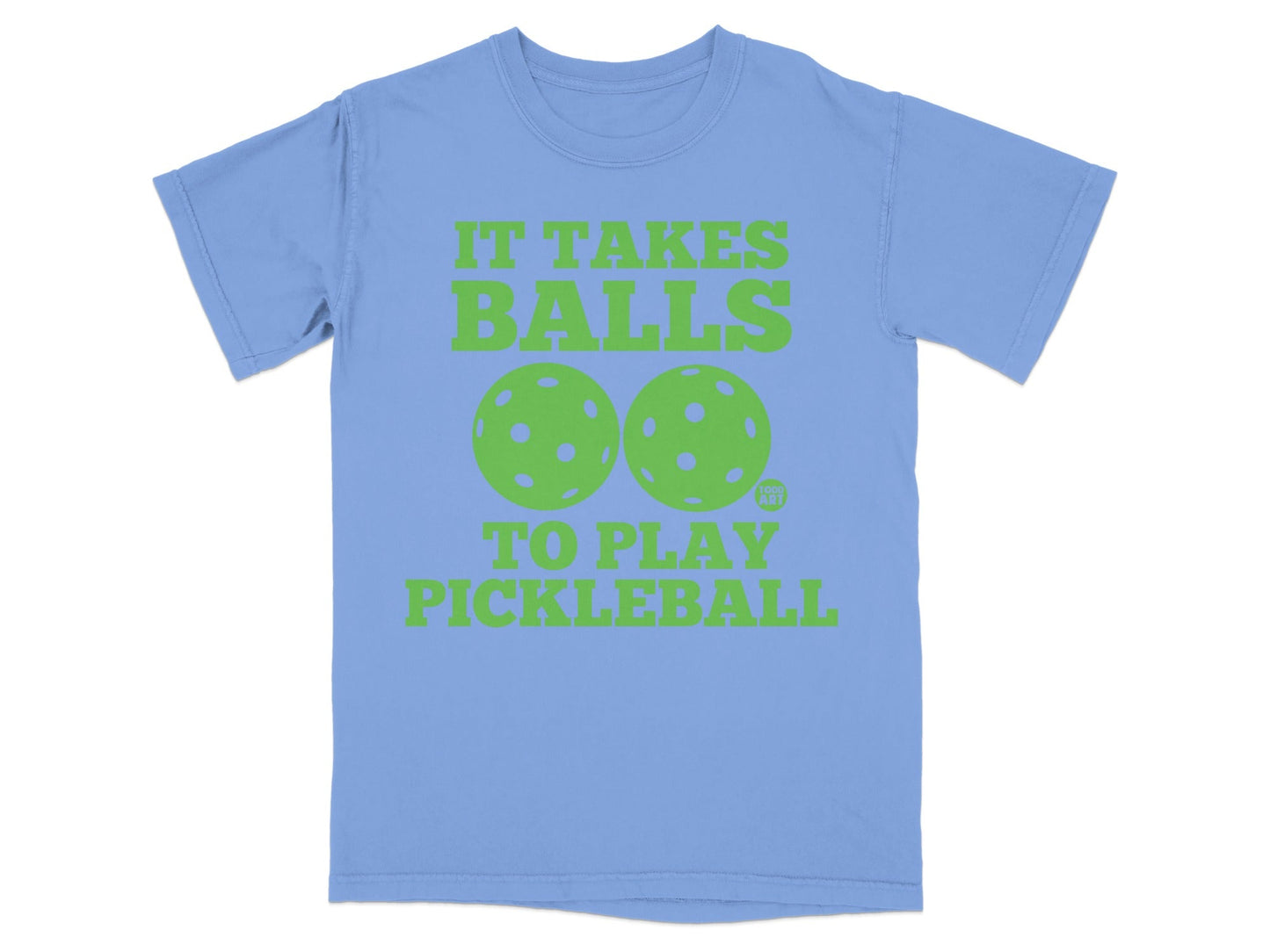 Light blue t-shirt with green text "IT TAKES BALLS TO PLAY PICKLEBALL" and two pickleballs.