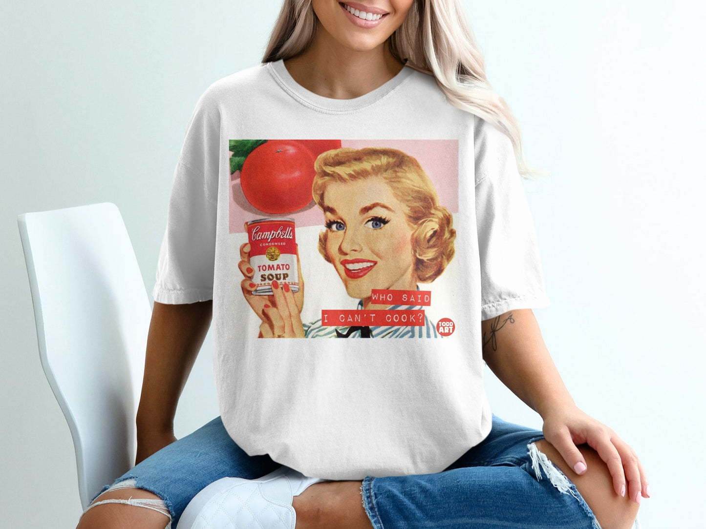 Woman in t-shirt holding Campbell's Tomato Soup can, "Who Said I Can't Cook?".