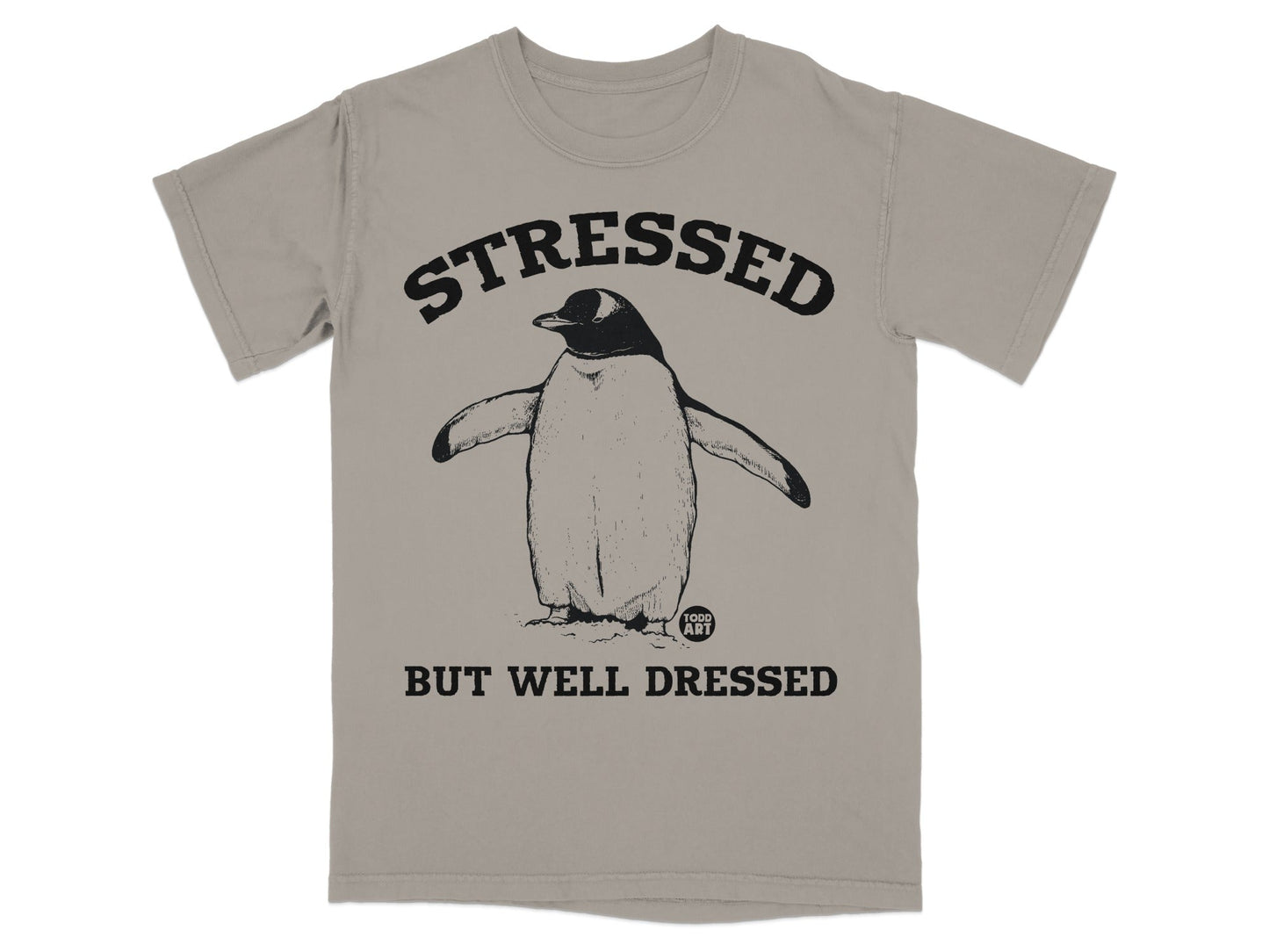 T-shirt with penguin graphic and text "STRESSED BUT WELL DRESSED."