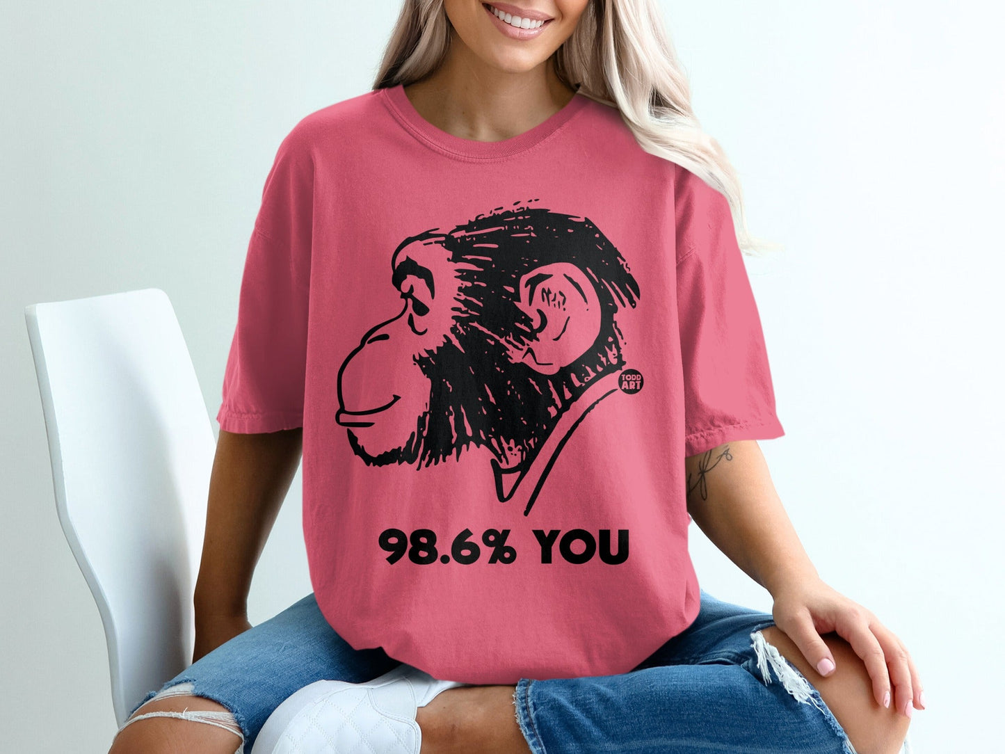 Pink t-shirt with a black chimpanzee head and "98.6% YOU" text.