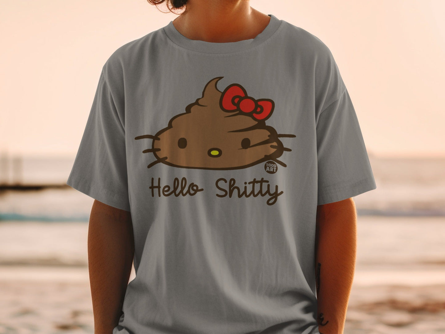 Grey t-shirt with a Hello Kitty-like poop emoji wearing a red bow.