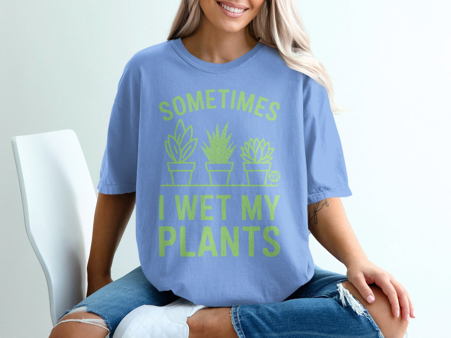 Light blue t-shirt with green text "Sometimes I wet my plants" and plant graphics.