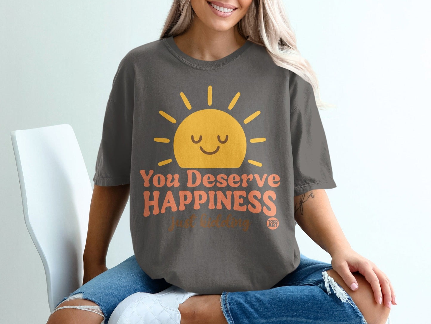 Dark gray t-shirt with a smiling sun and "You Deserve Happiness" text.