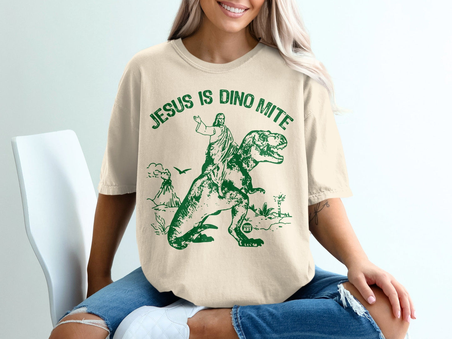 Jesus is Dino Mite graphic tee with Jesus riding a T-Rex.