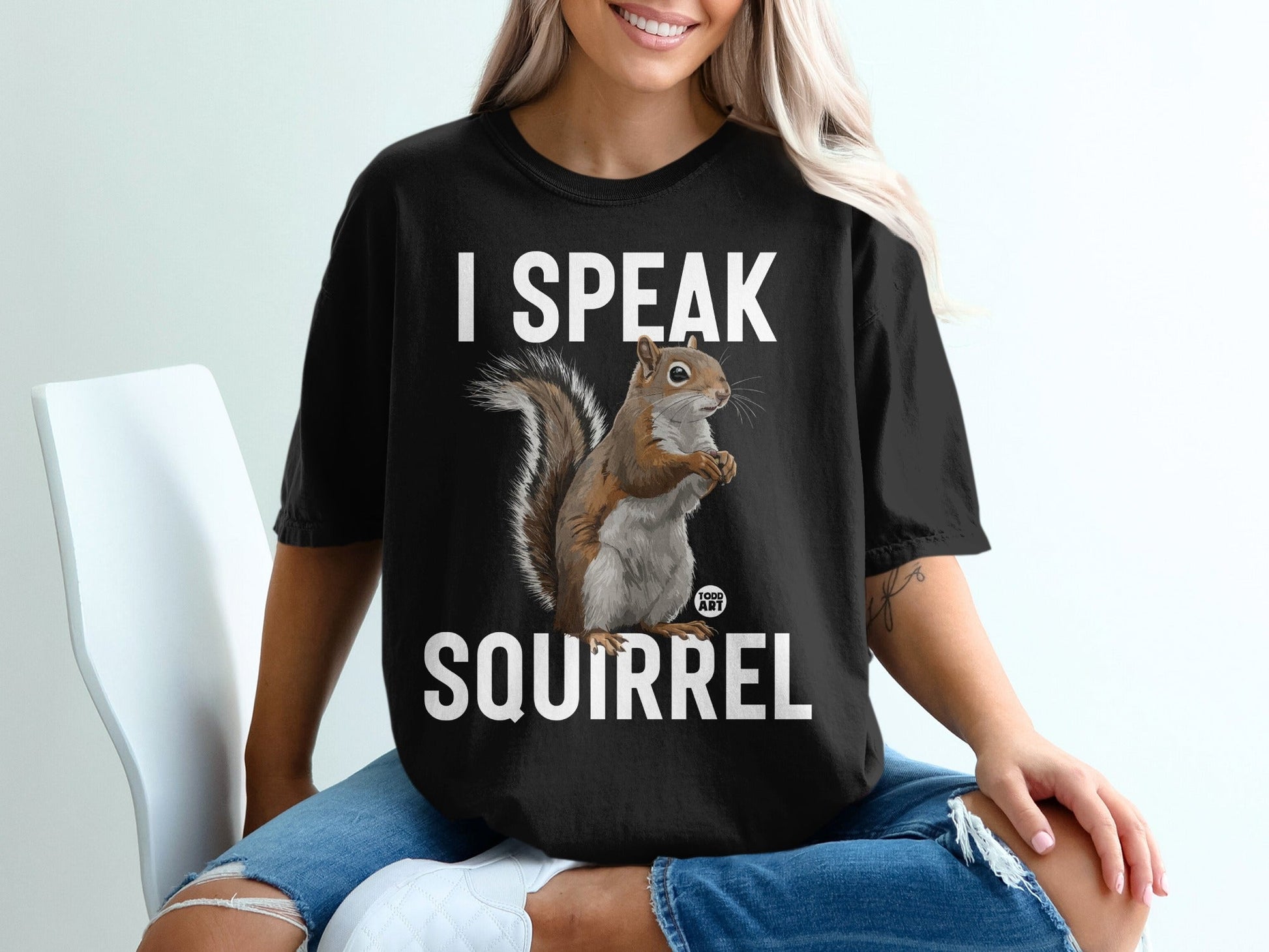 Black t-shirt with white text "I SPEAK SQUIRREL" and a squirrel graphic.