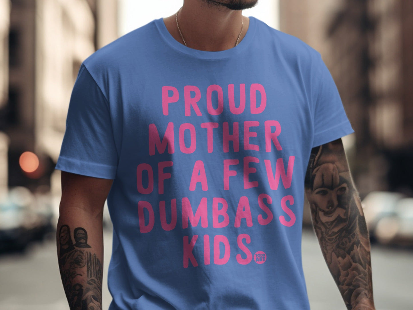 Blue t-shirt with "Proud Mother of a Few Dumbass Kids" in pink text.
