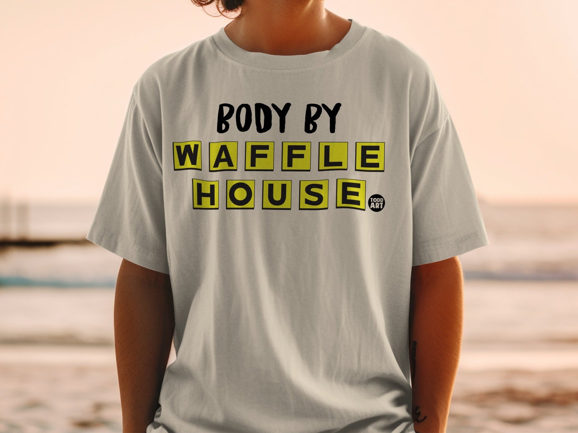 Grey t-shirt with "BODY BY WAFFLE HOUSE" text and a small logo.