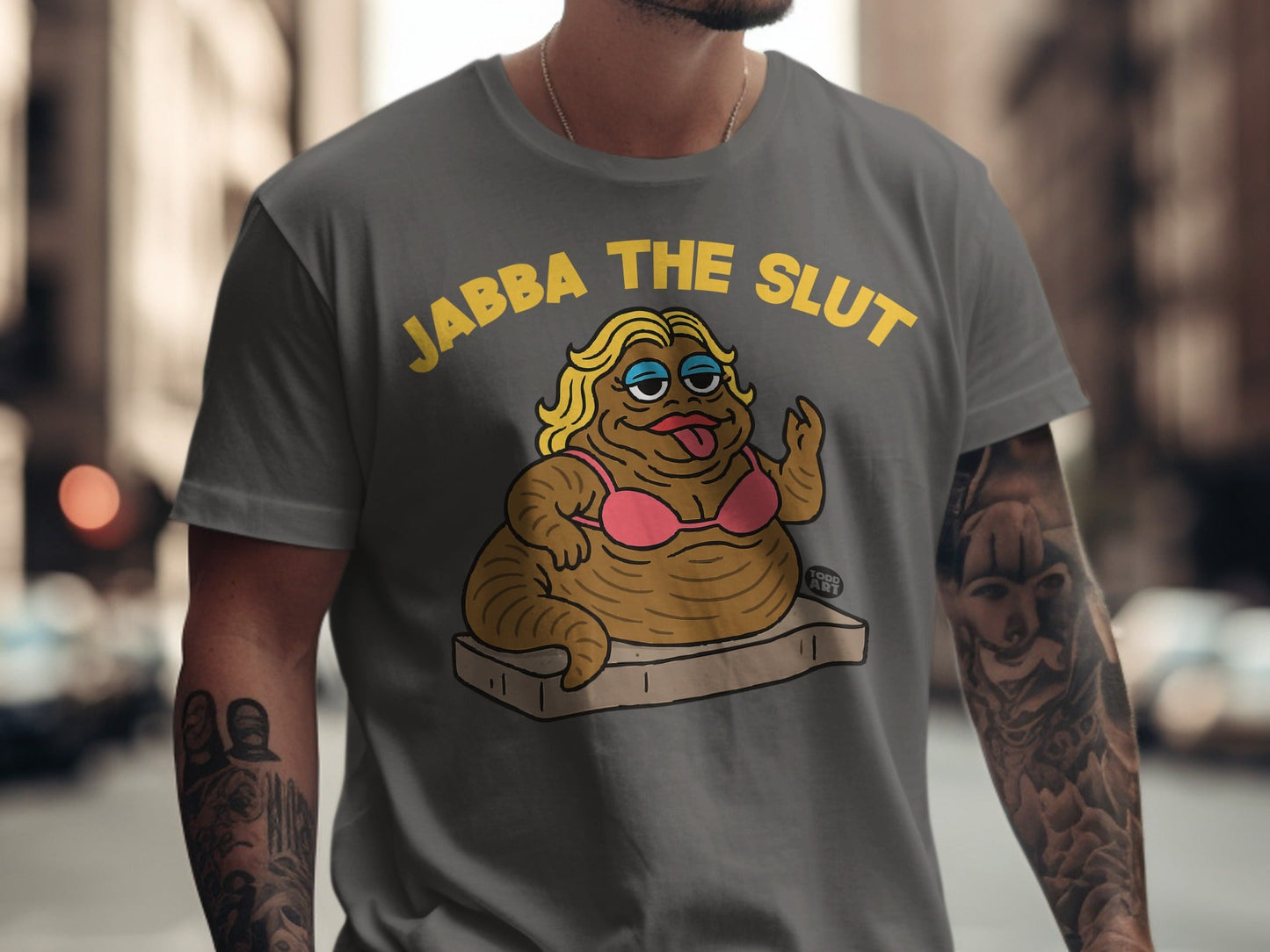 Grey t-shirt with Jabba the Slut in pink bikini on a mattress.