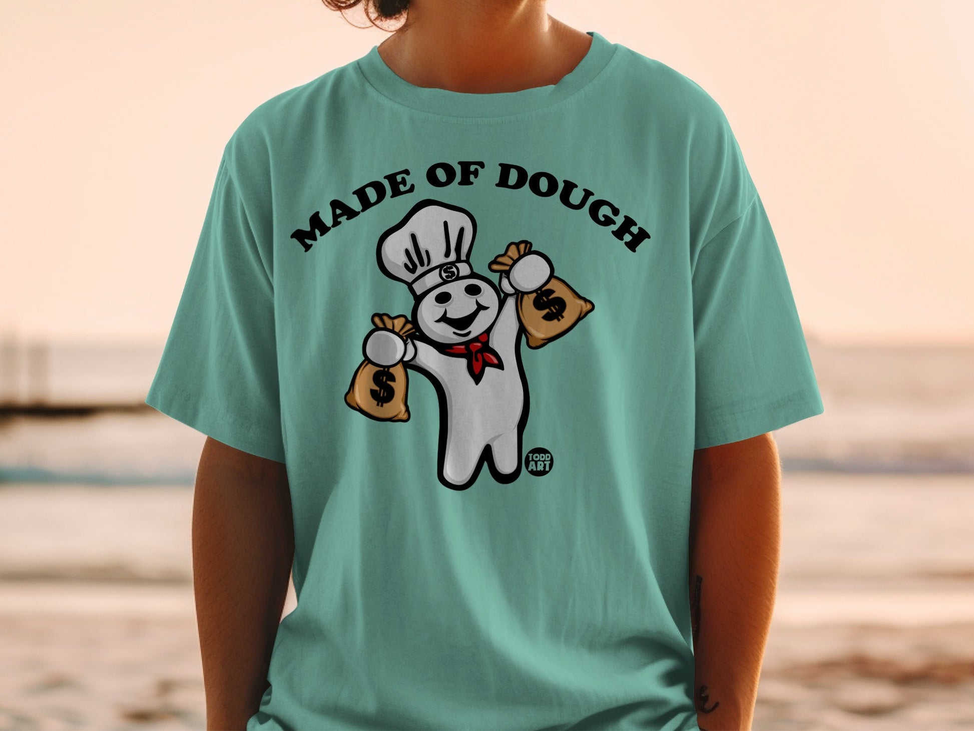Pillsbury Doughboy in chef hat holding money bags, text "Made of Dough".