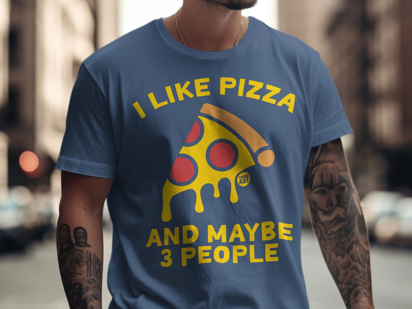 Blue t-shirt with text "I LIKE PIZZA AND MAYBE 3 PEOPLE" and a pizza slice graphic.