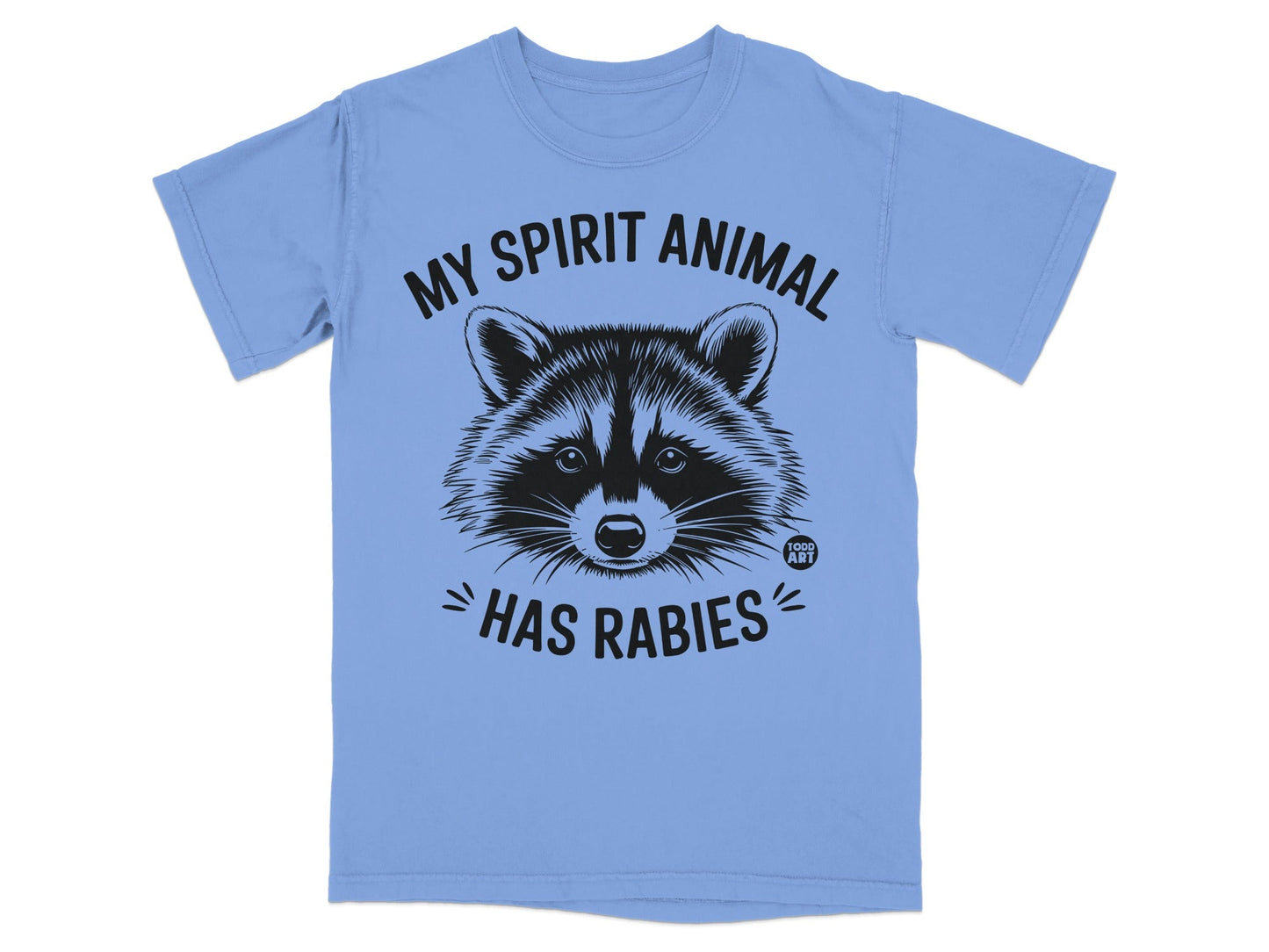 Light blue t-shirt with black graphic of a raccoon face and text "MY SPIRIT ANIMAL HAS RABIES".