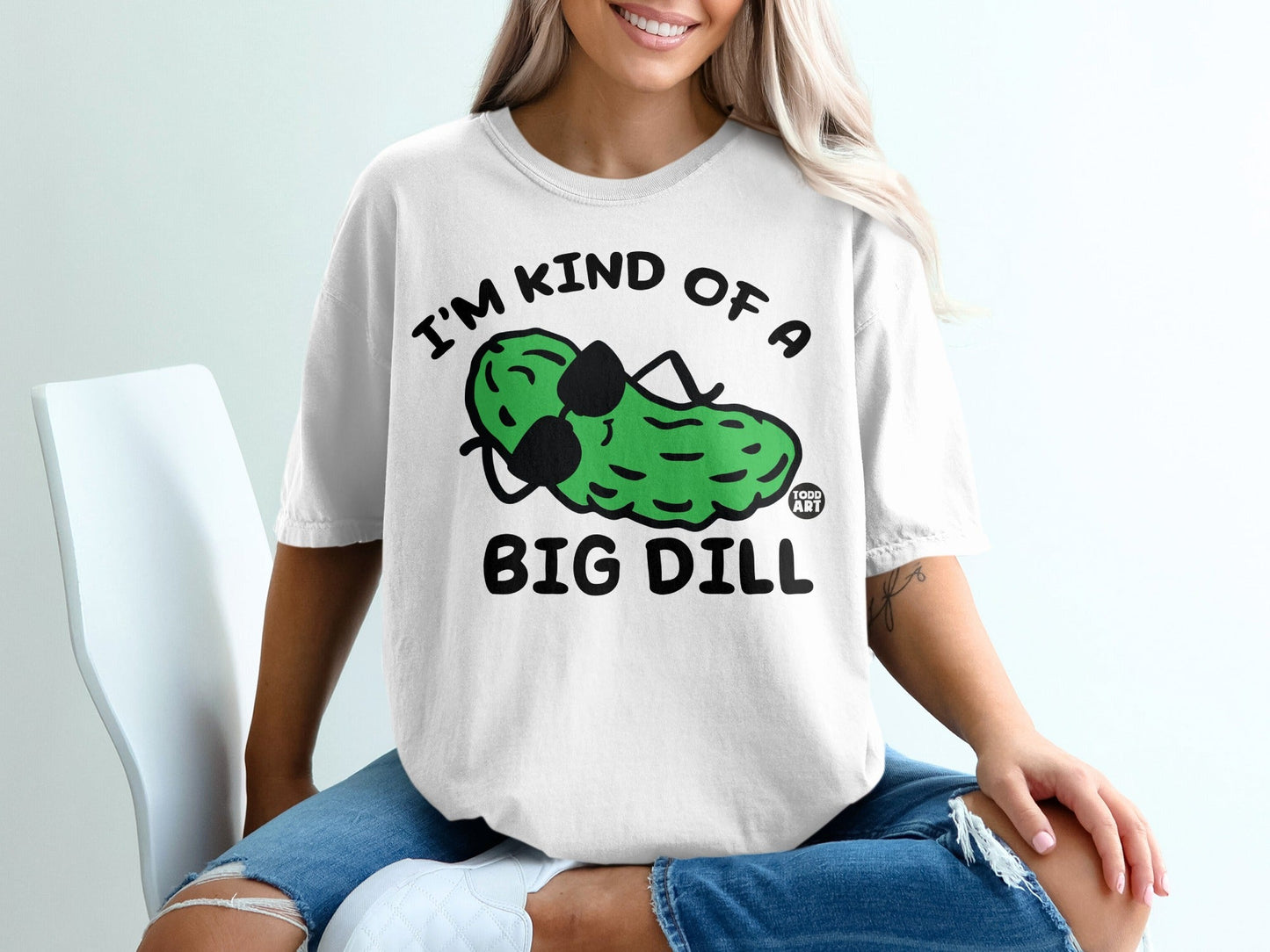 White t-shirt with "I'M KIND OF A BIG DILL" graphic of a pickle wearing sunglasses.