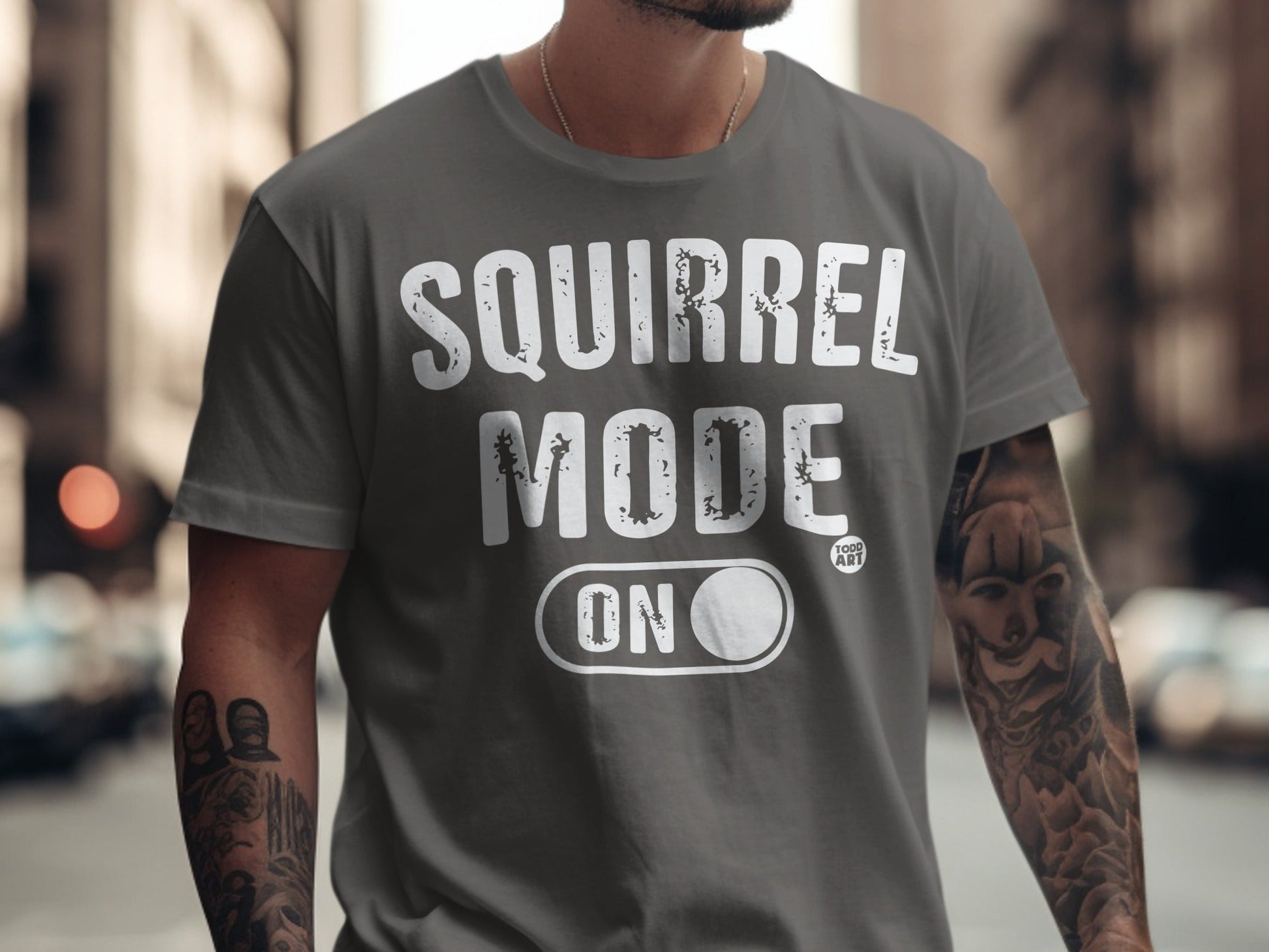 Gray t-shirt with "SQUIRREL MODE ON" text and a small "GOOD ART" logo.
