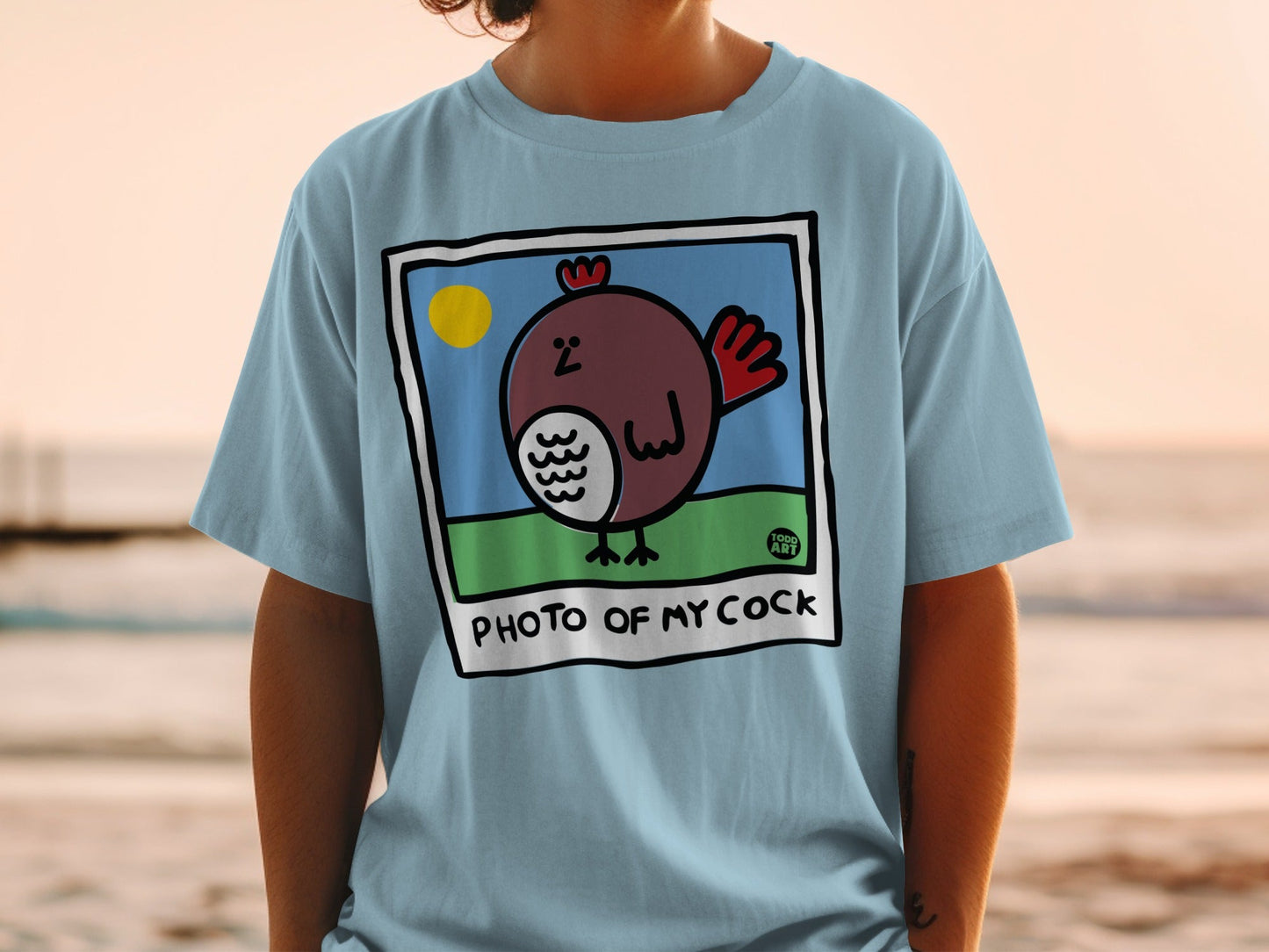 Light blue t-shirt with cartoon chicken and "PHOTO OF MY COCK" text.