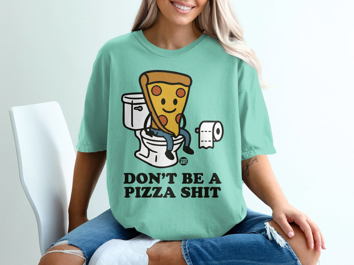 Mint t-shirt with cartoon pizza on toilet, reads "Don't be a pizza shit."