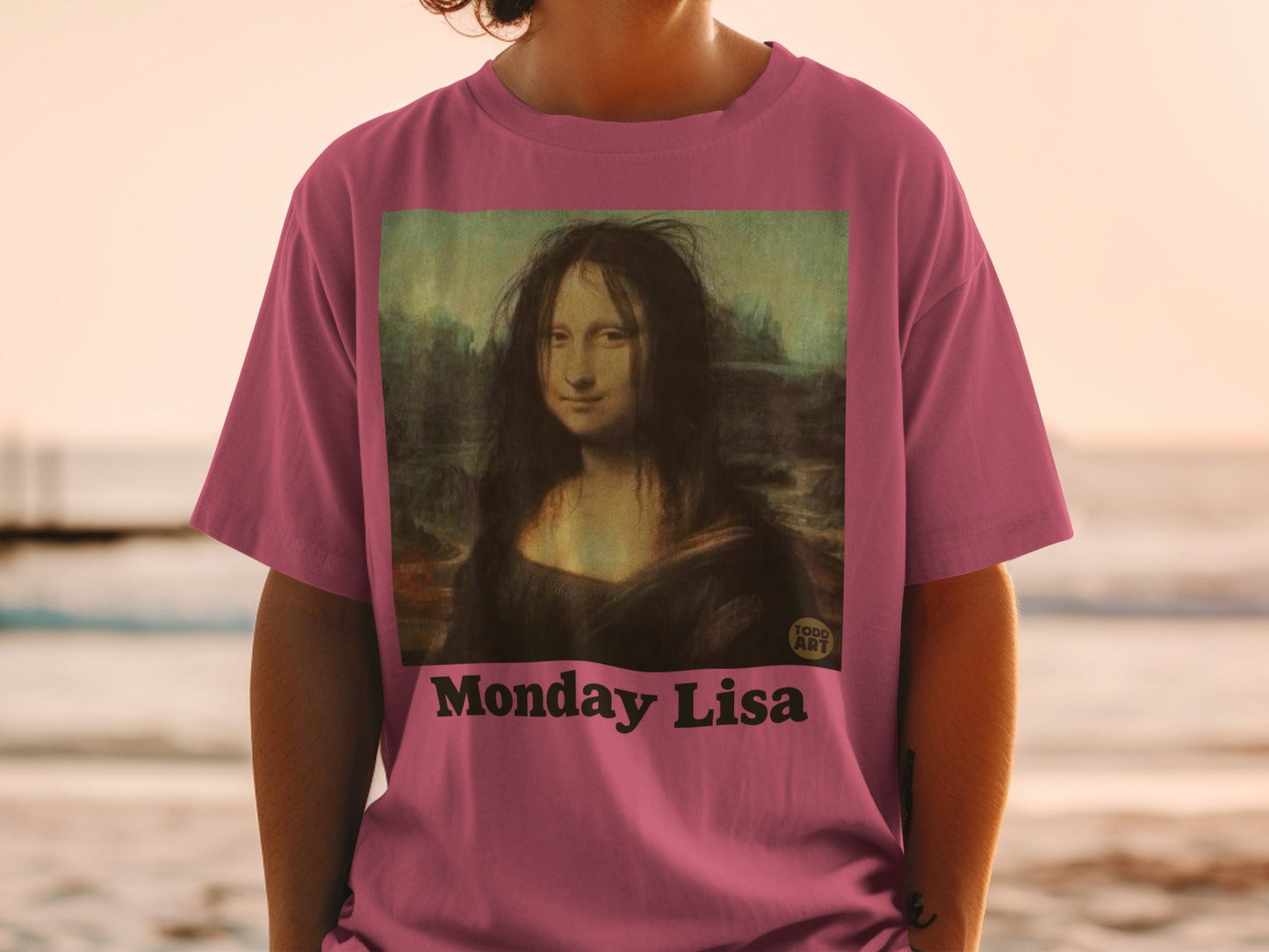 Mona Lisa with messy hair on a pink t-shirt, labeled "Monday Lisa".