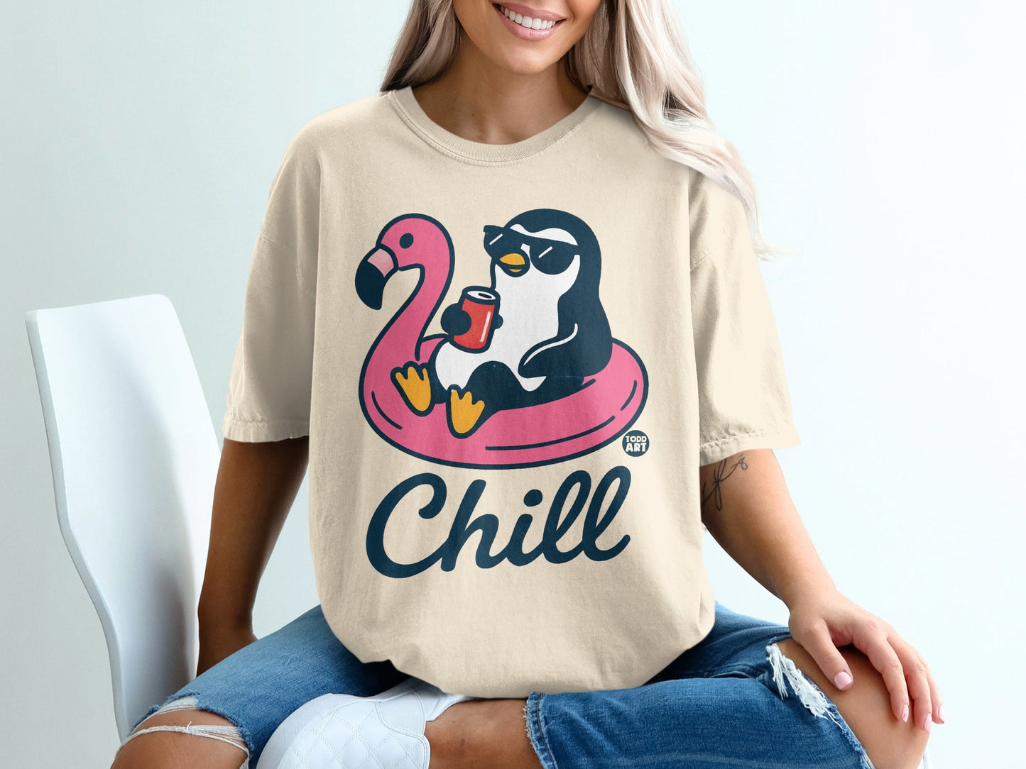Penguin in sunglasses floats on flamingo tube, holding a drink, text says "Chill".