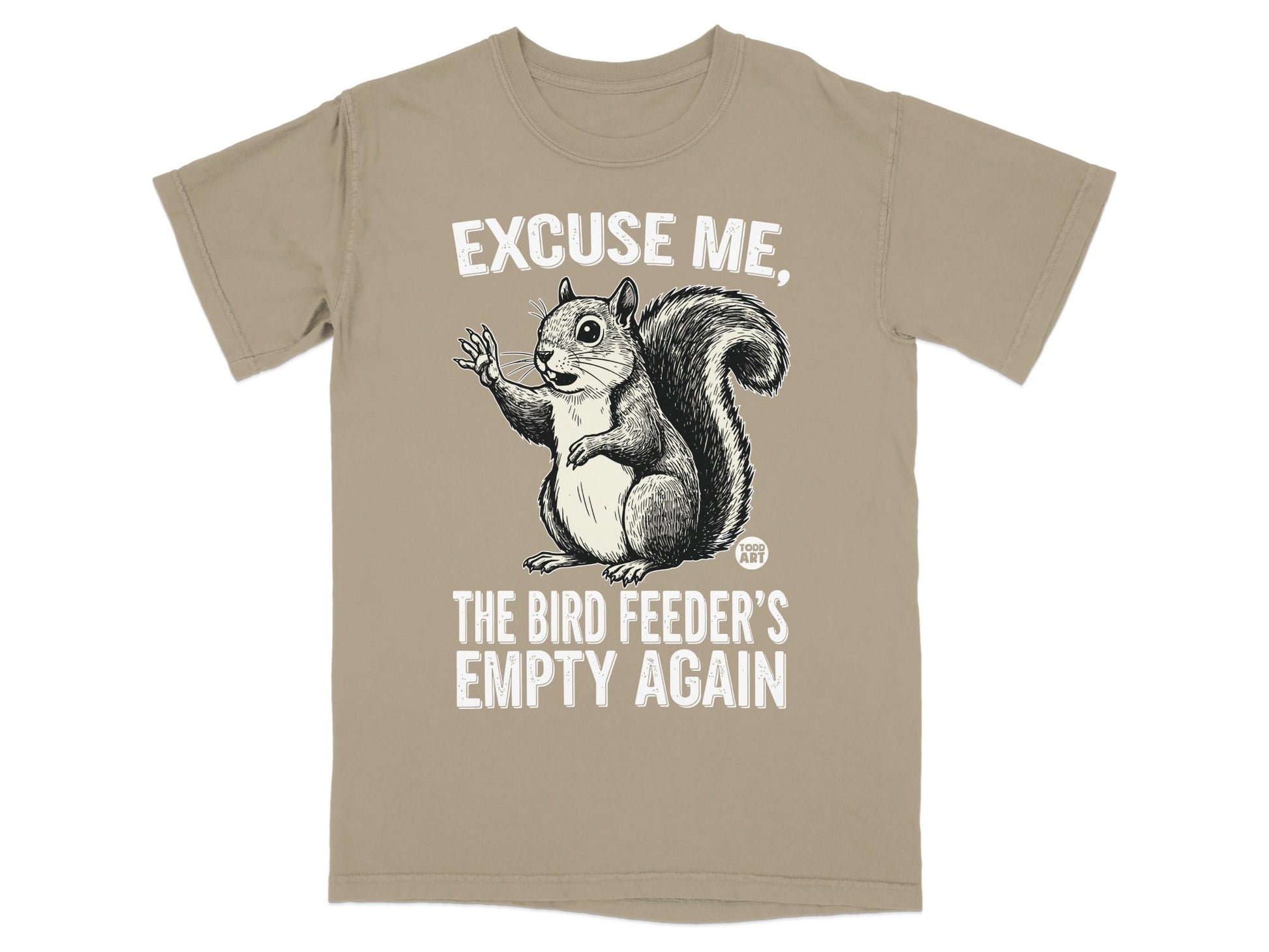 Squirrel graphic on a tan t-shirt saying "Excuse me, the bird feeder's empty again."