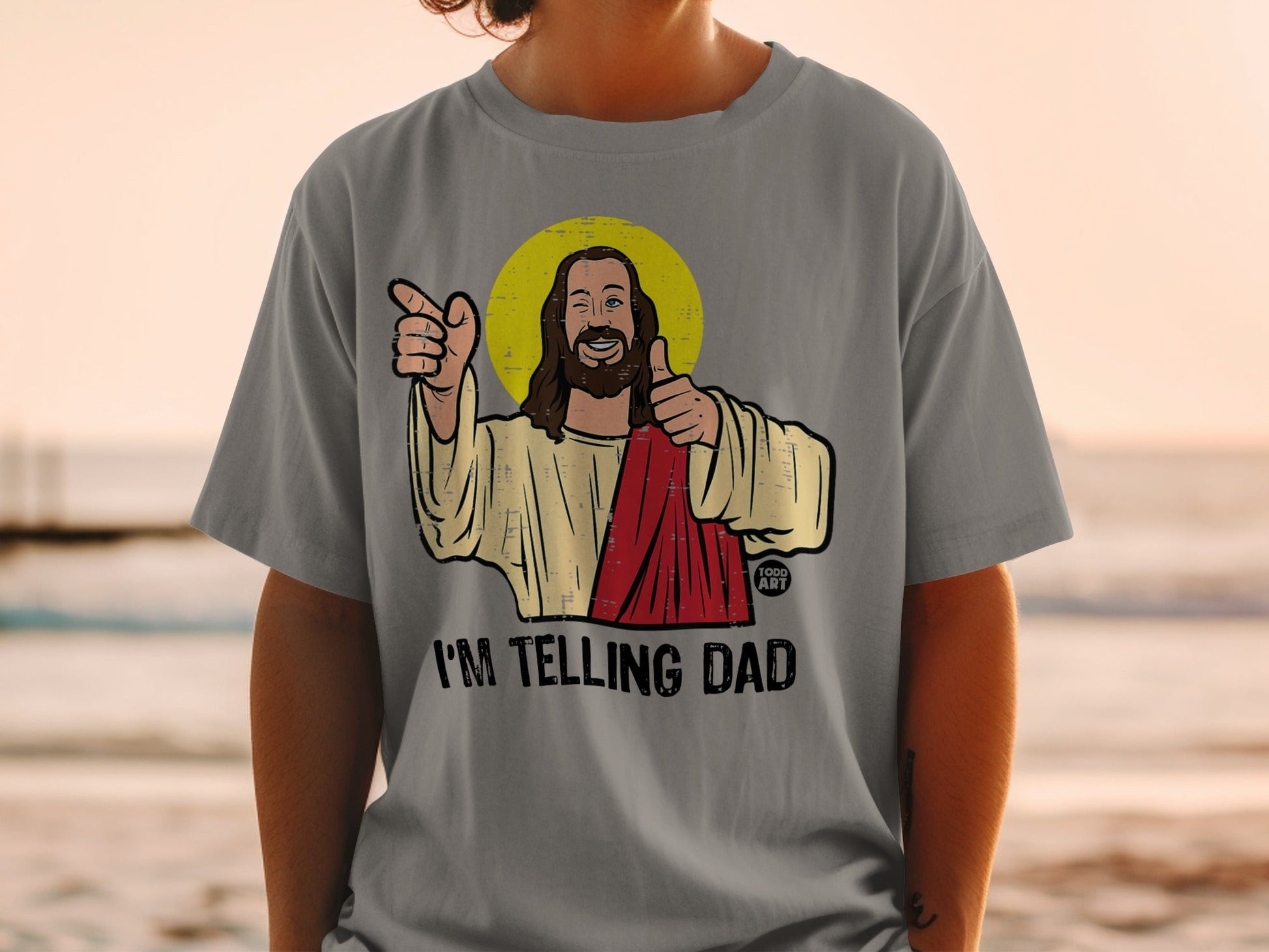 Jesus with halo gives a thumbs up and points, "I'm Telling Dad."