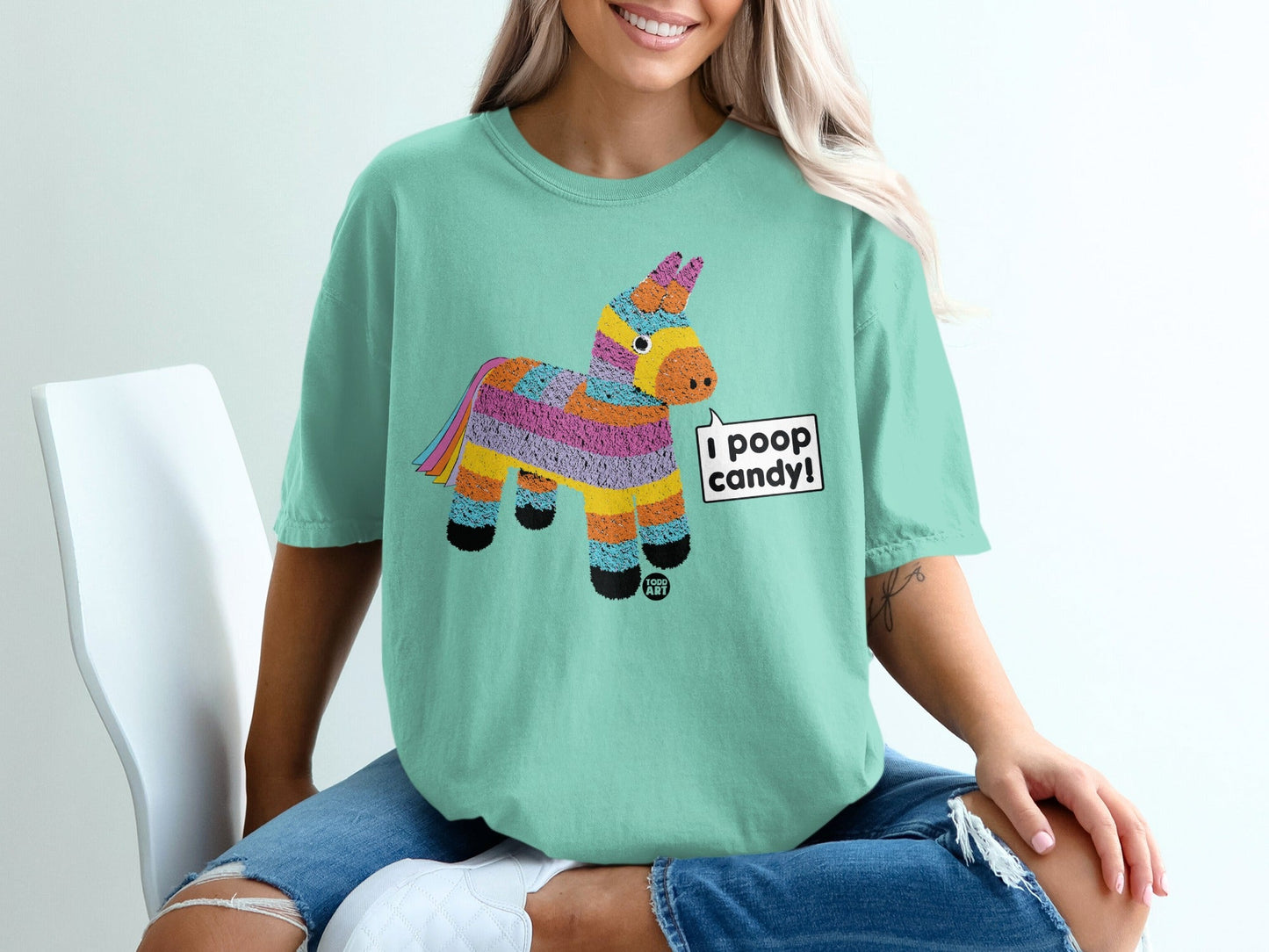 Teal t-shirt with colorful pinata graphic that says "I poop candy!".