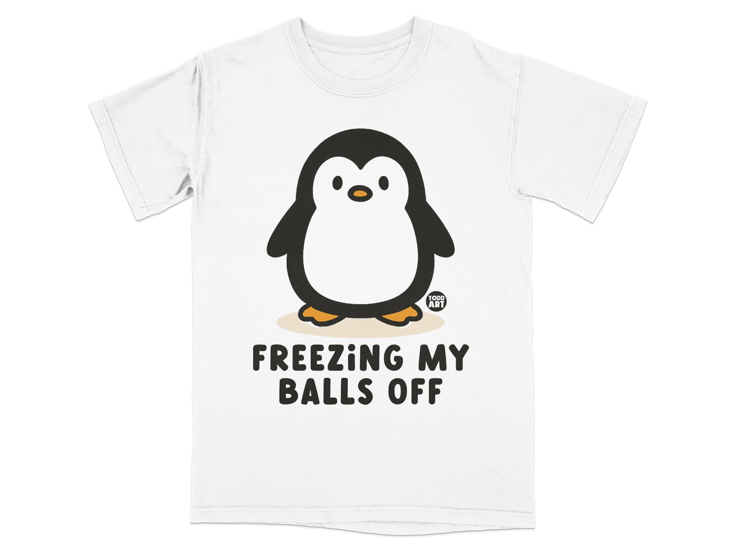 White t-shirt with a cartoon penguin and text "FREEZING MY BALLS OFF".