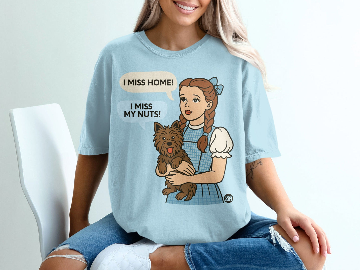 Dorothy holding Toto, with speech bubbles saying "I miss home!" and "I miss my nuts!".