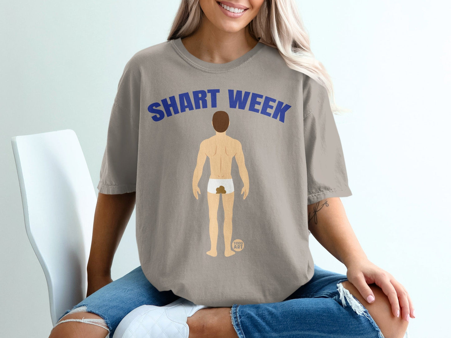 T-shirt with "SHART WEEK" text and cartoon of a person with underwear stained.