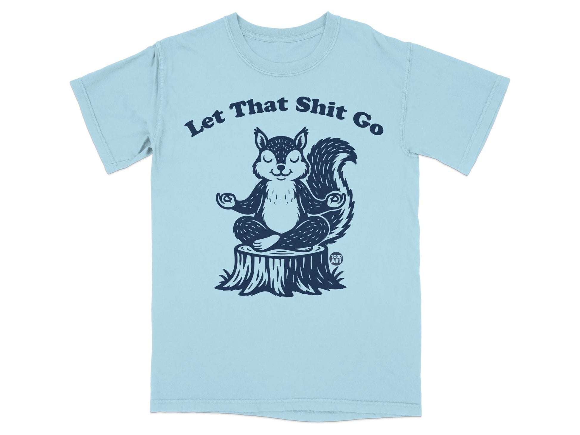 Light blue t-shirt with a meditating squirrel on a tree stump, text "Let That Shit Go".