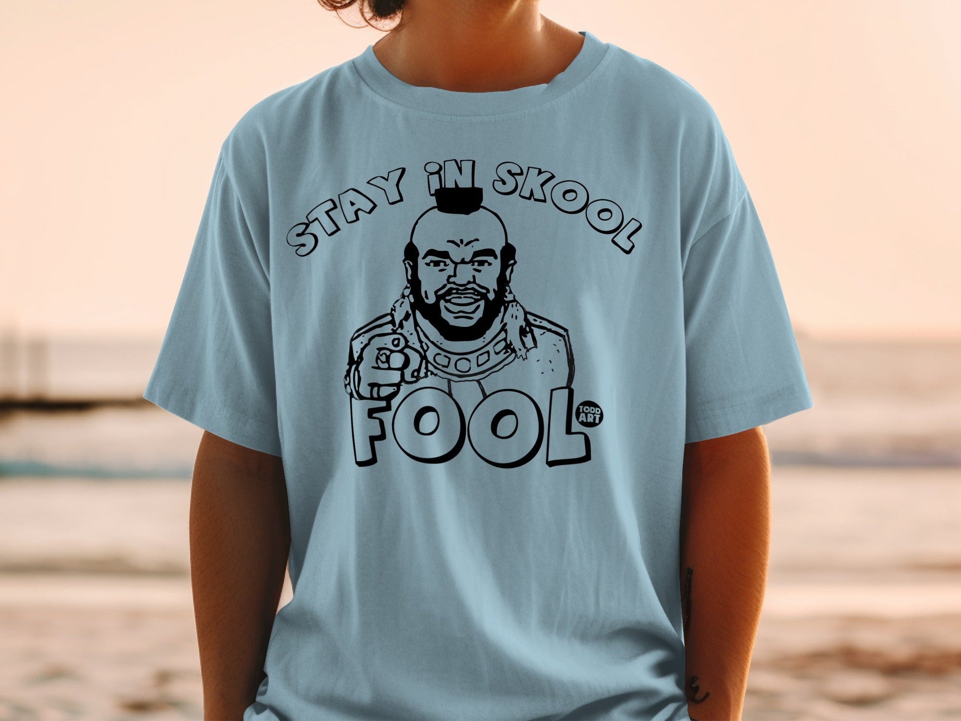 Light blue t-shirt with "Stay in Skool Fool" and Mr. T graphic.