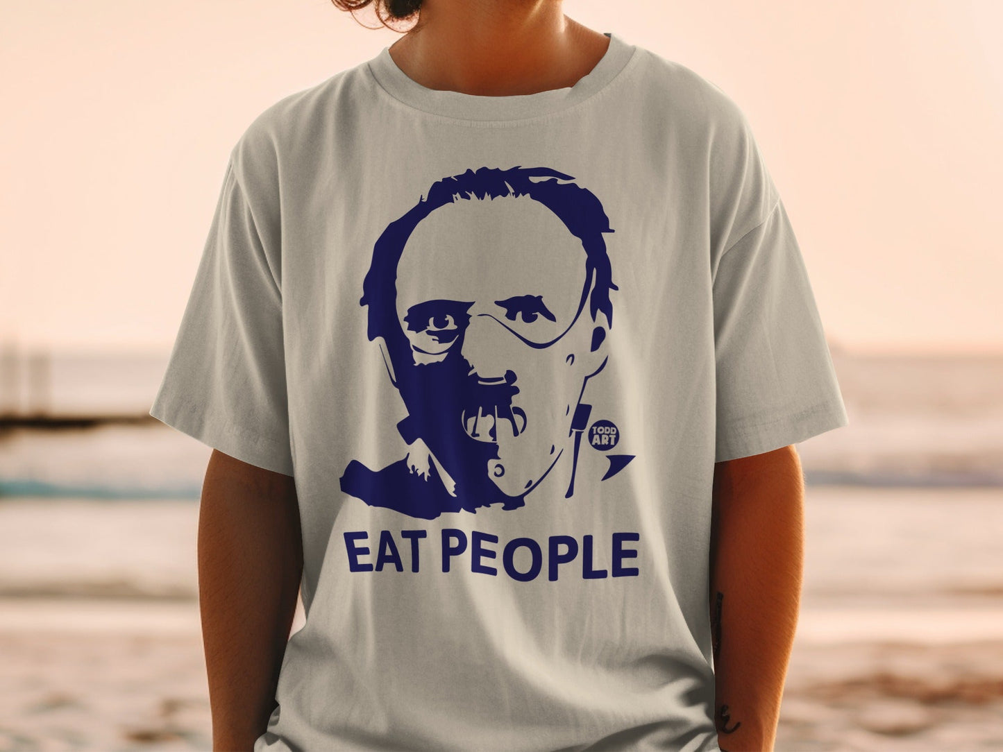 Blue graphic t-shirt with "Eat People" text and a stylized face.